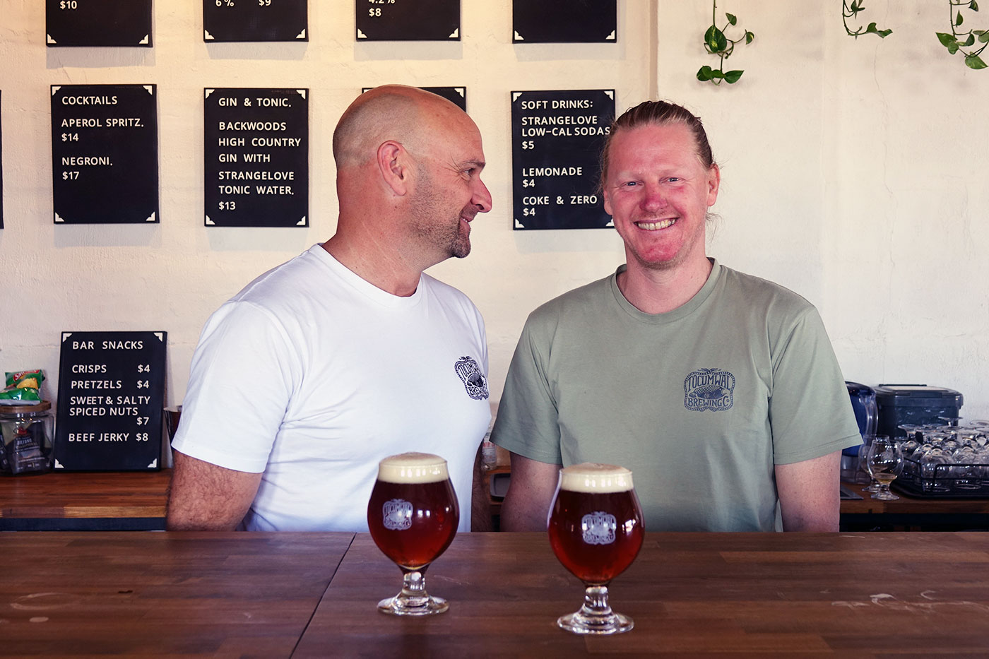 Two members of the brewery team at the bar