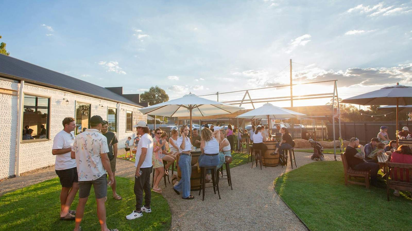 Visitors gathering in the brewery beer garden at sunset